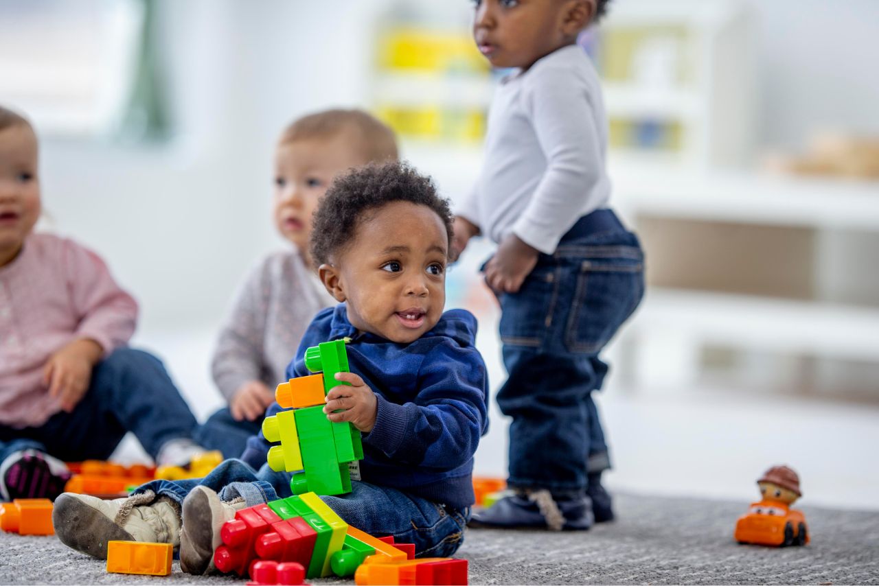 Toddlers playing with blocks.