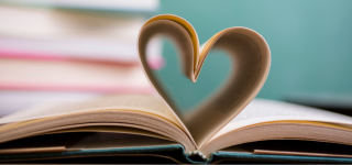 Book pages folded in the shape of a heart.