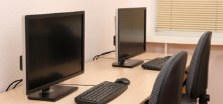 Two computers side-by-side on a desk.