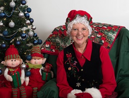 Mrs Carol Claus posing with elves 