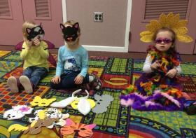 Children trying on dress-up costumes
